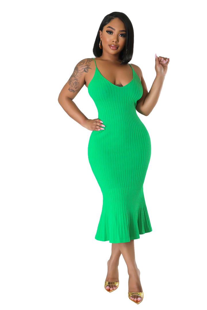 a woman in a green dress posing for a picture