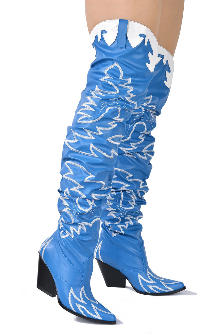 a close up of a person wearing a pair of blue boots
