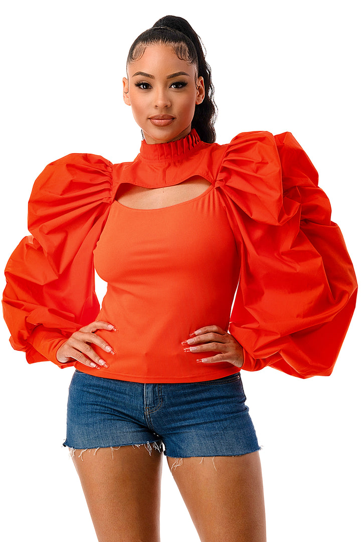 a woman wearing a red top and denim shorts