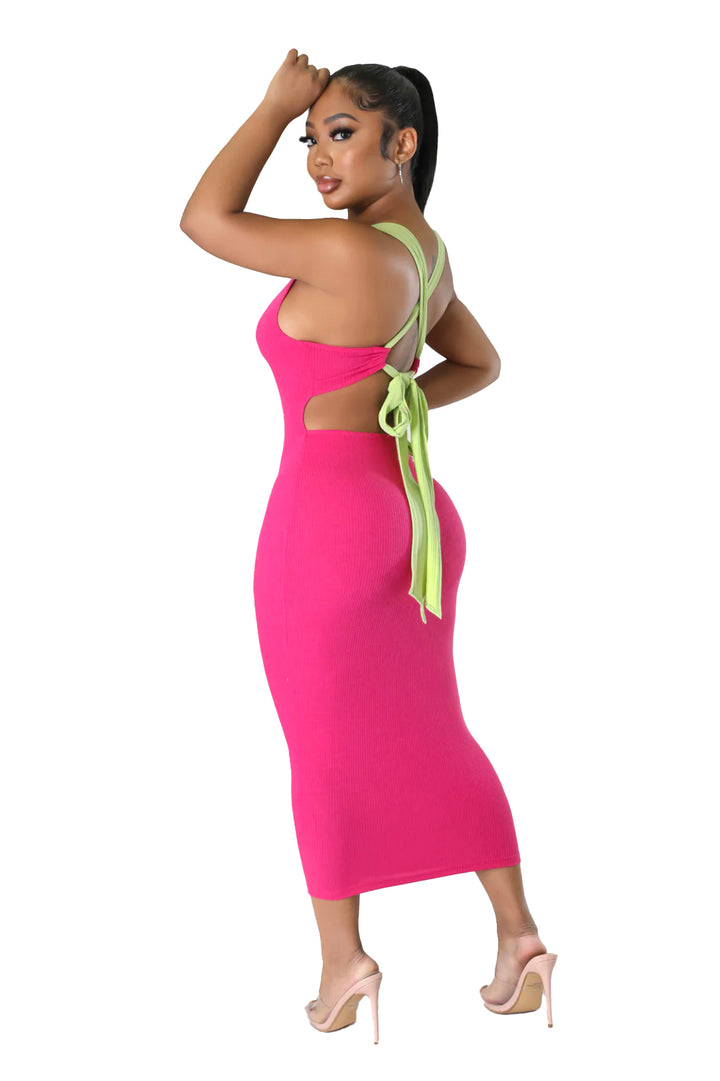 a woman in a pink dress with a green tie