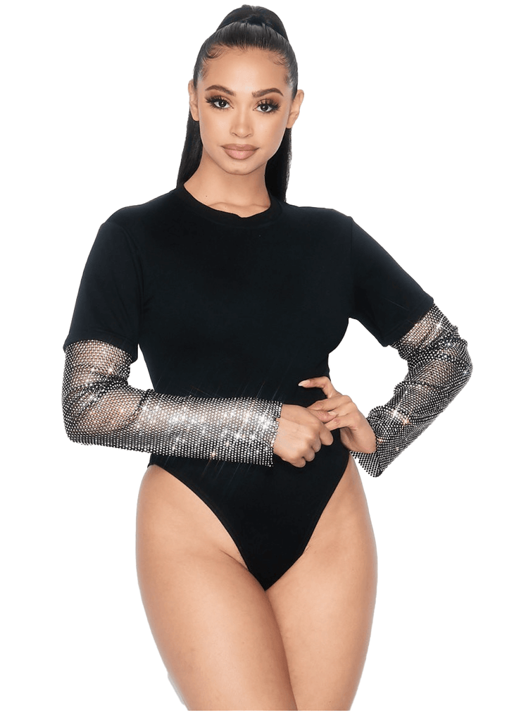 a woman in a black bodysuit with long sleeves