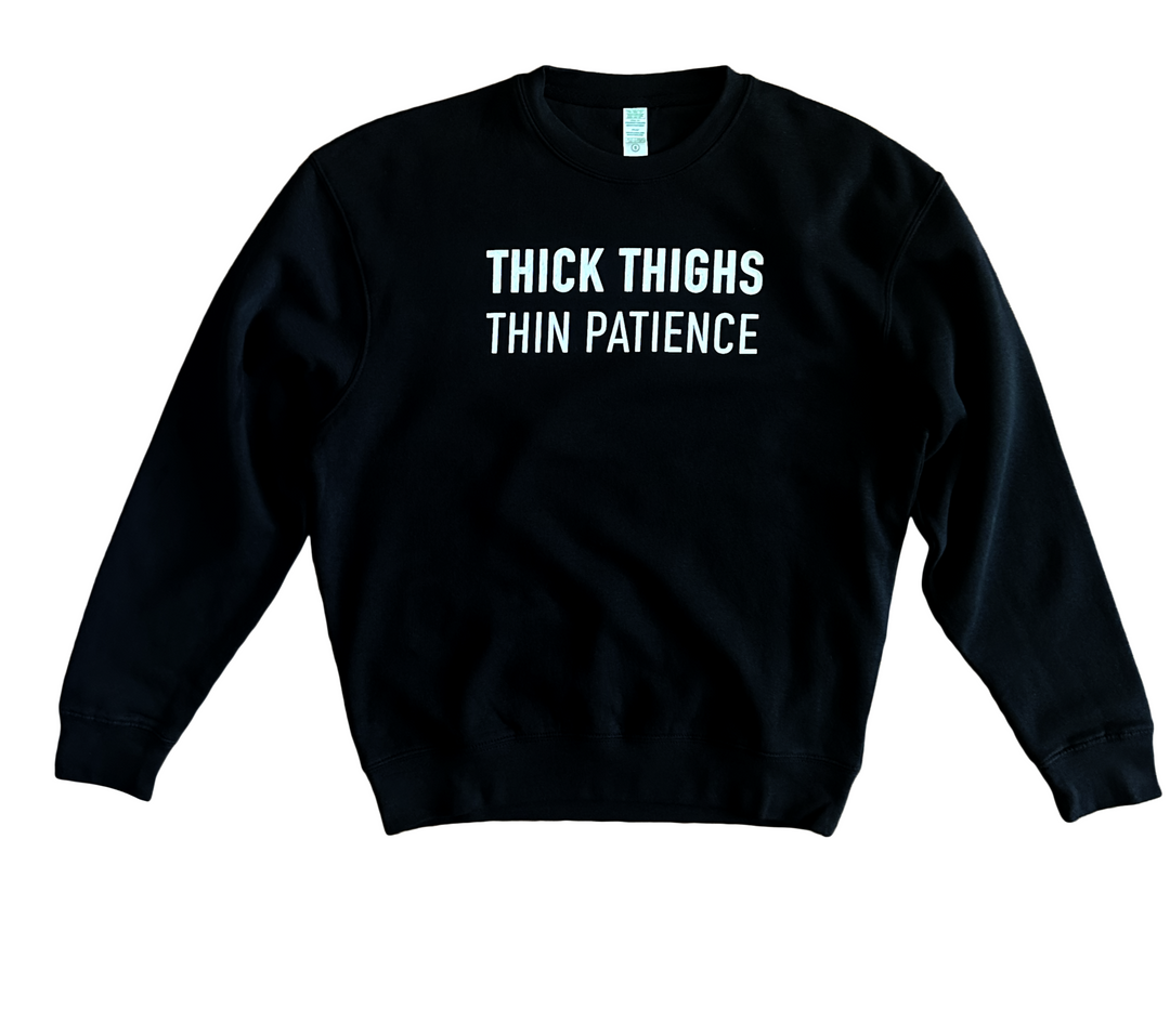a black sweatshirt that says thick thighs thin patience