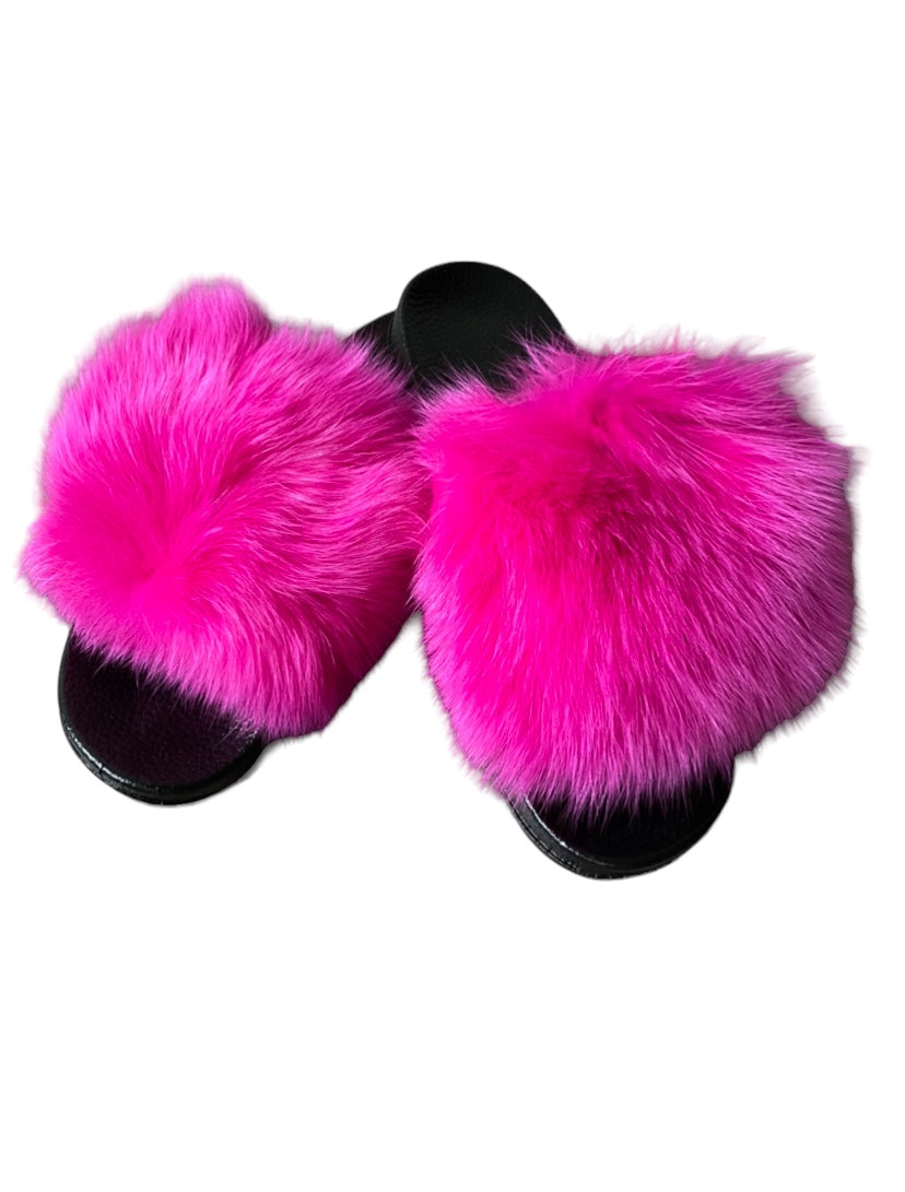 a pair of pink furry slippers on a white background