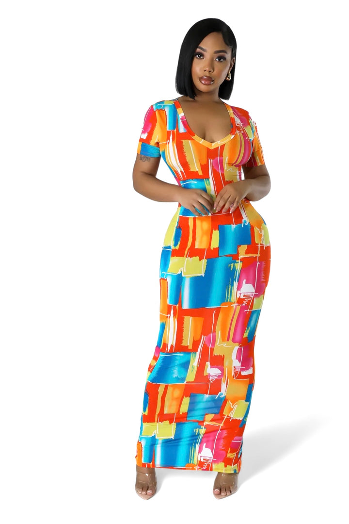 a woman in a colorful dress posing for a picture