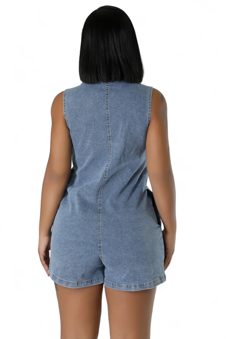a woman wearing a denim romper and shorts