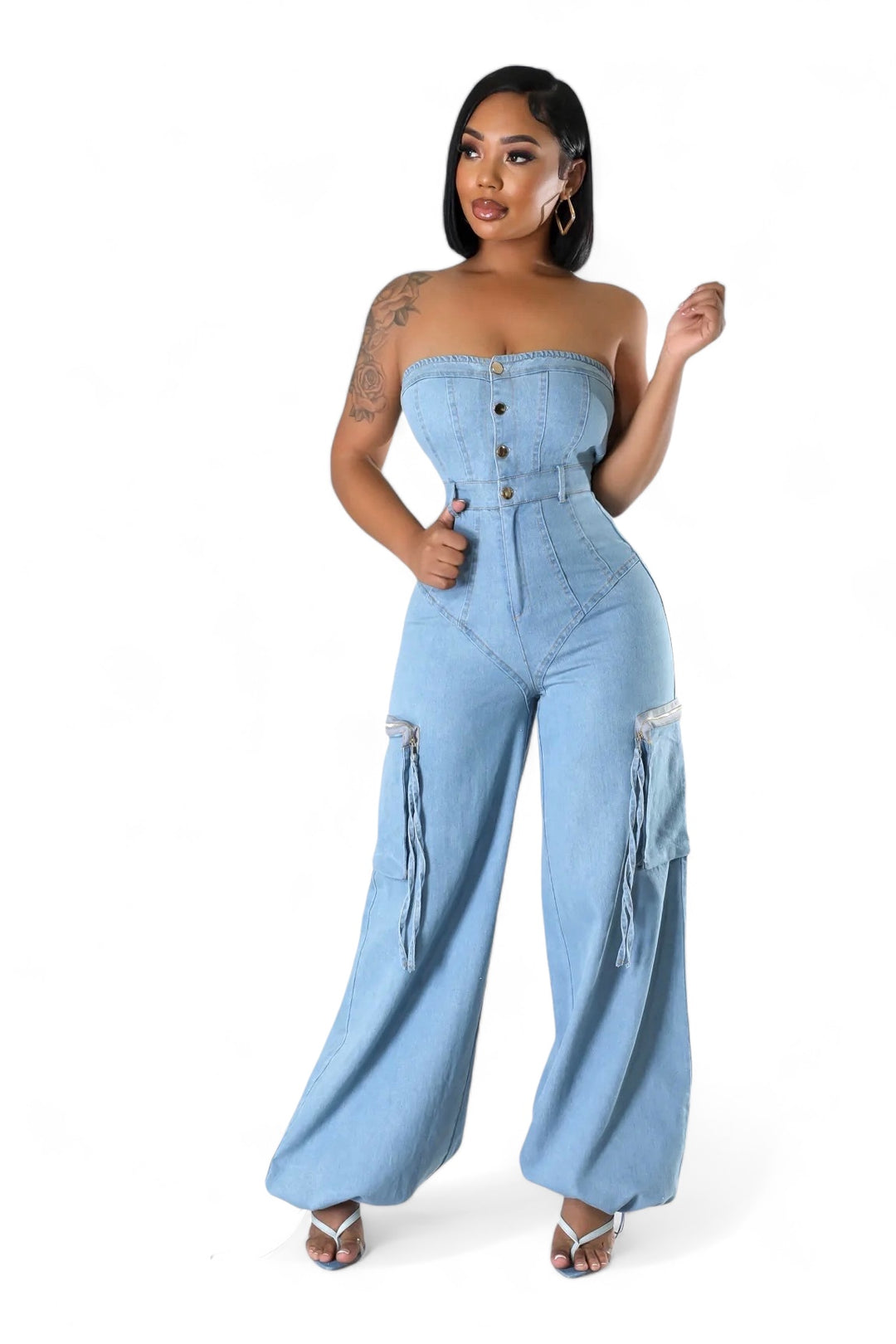 a woman in a denim jumpsuit posing for a picture