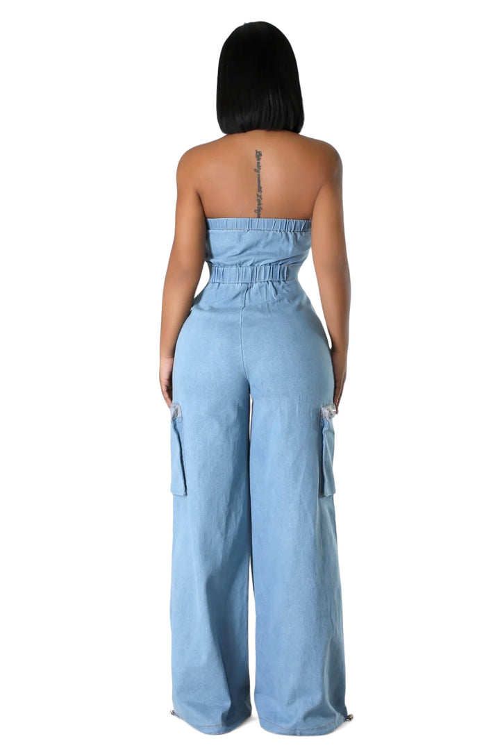 the back of a woman wearing a denim jumpsuit with pockets