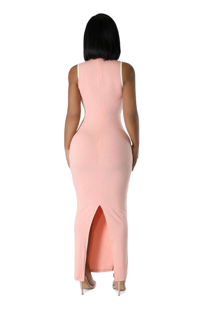 a woman wearing a pink dress with a high slit