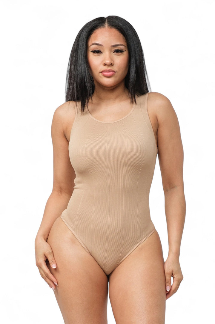 a woman in a bodysuit posing for the camera