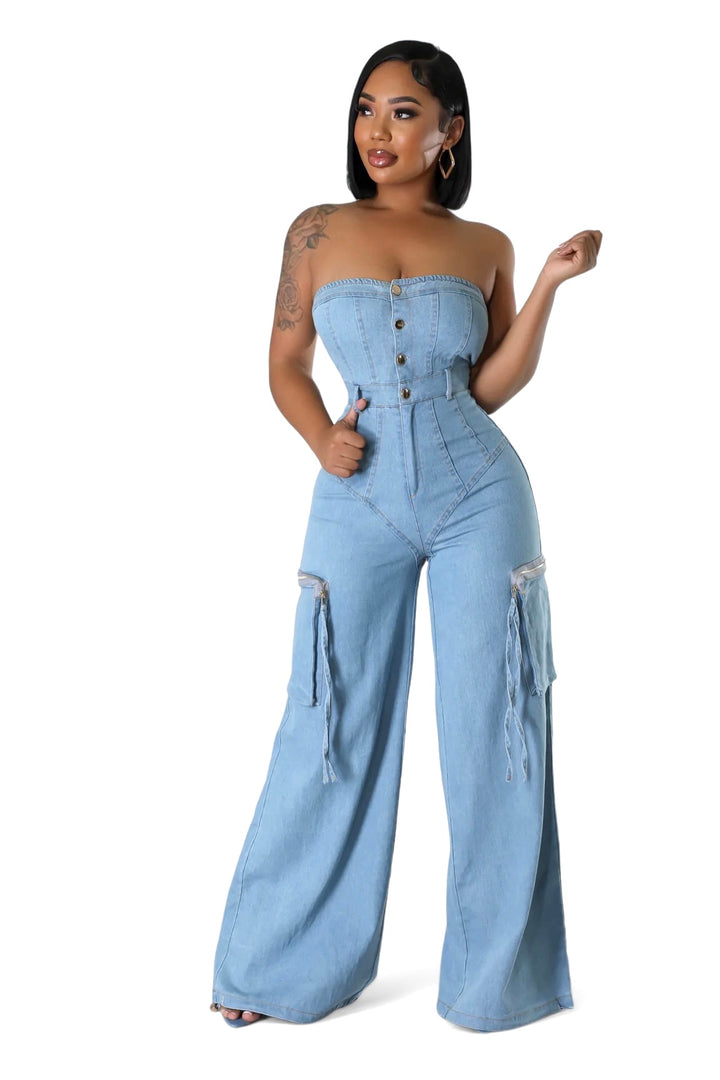 a woman wearing a denim jumpsuit and heels