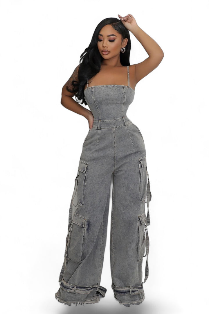 a woman in grey jumpsuits posing for the camera