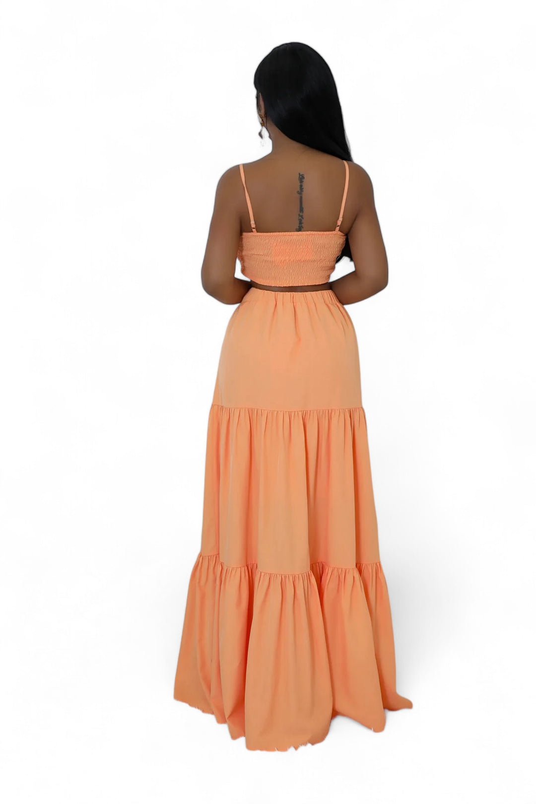 the back of a woman wearing an orange dress