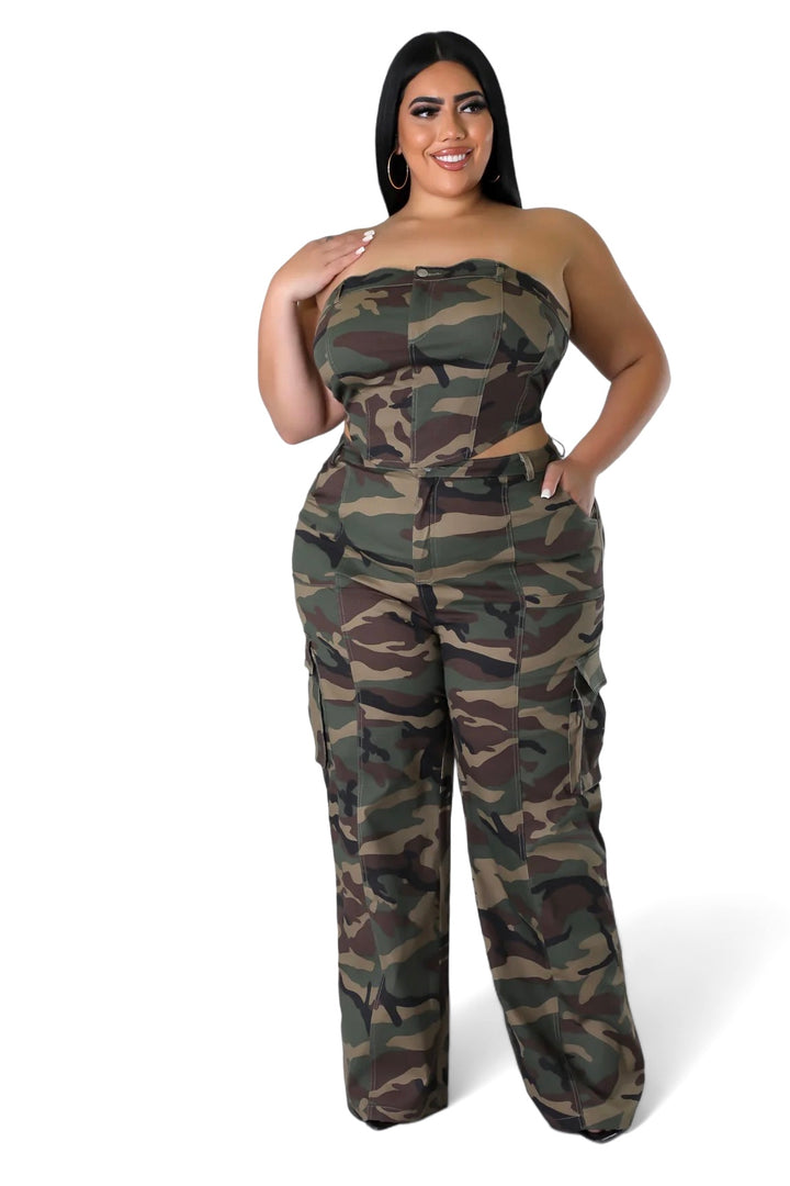 a woman wearing a camo jumpsuit and heels