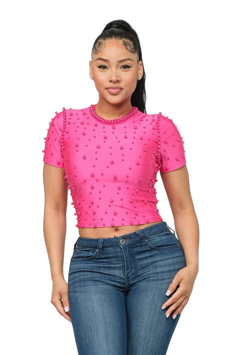 a woman wearing a pink top and jeans