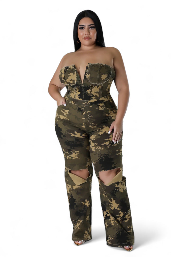 a woman in a camo jumpsuit posing for the camera