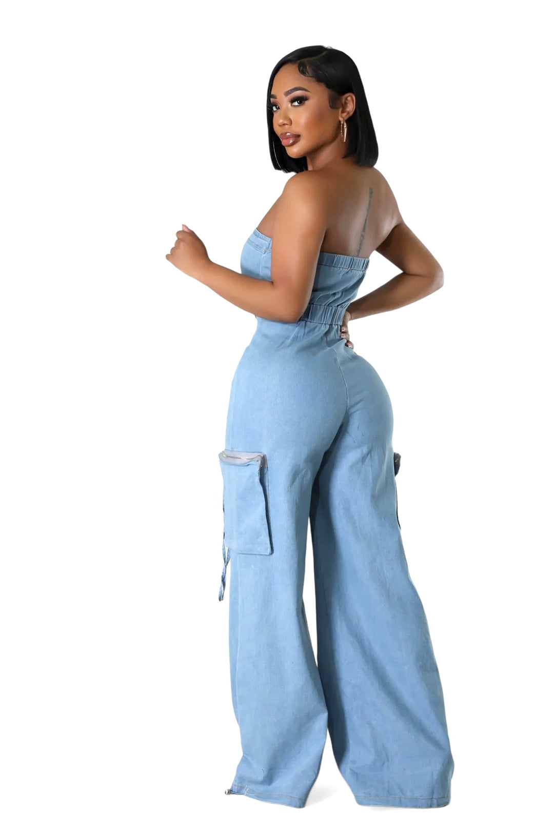 the side angle a woman in a blue jumpsuit posing for a picture