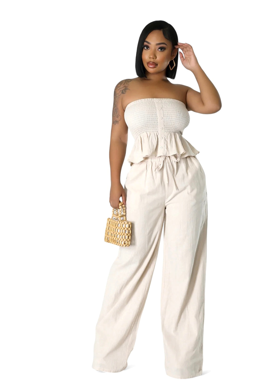 a woman in a strapless top and wide legged pants