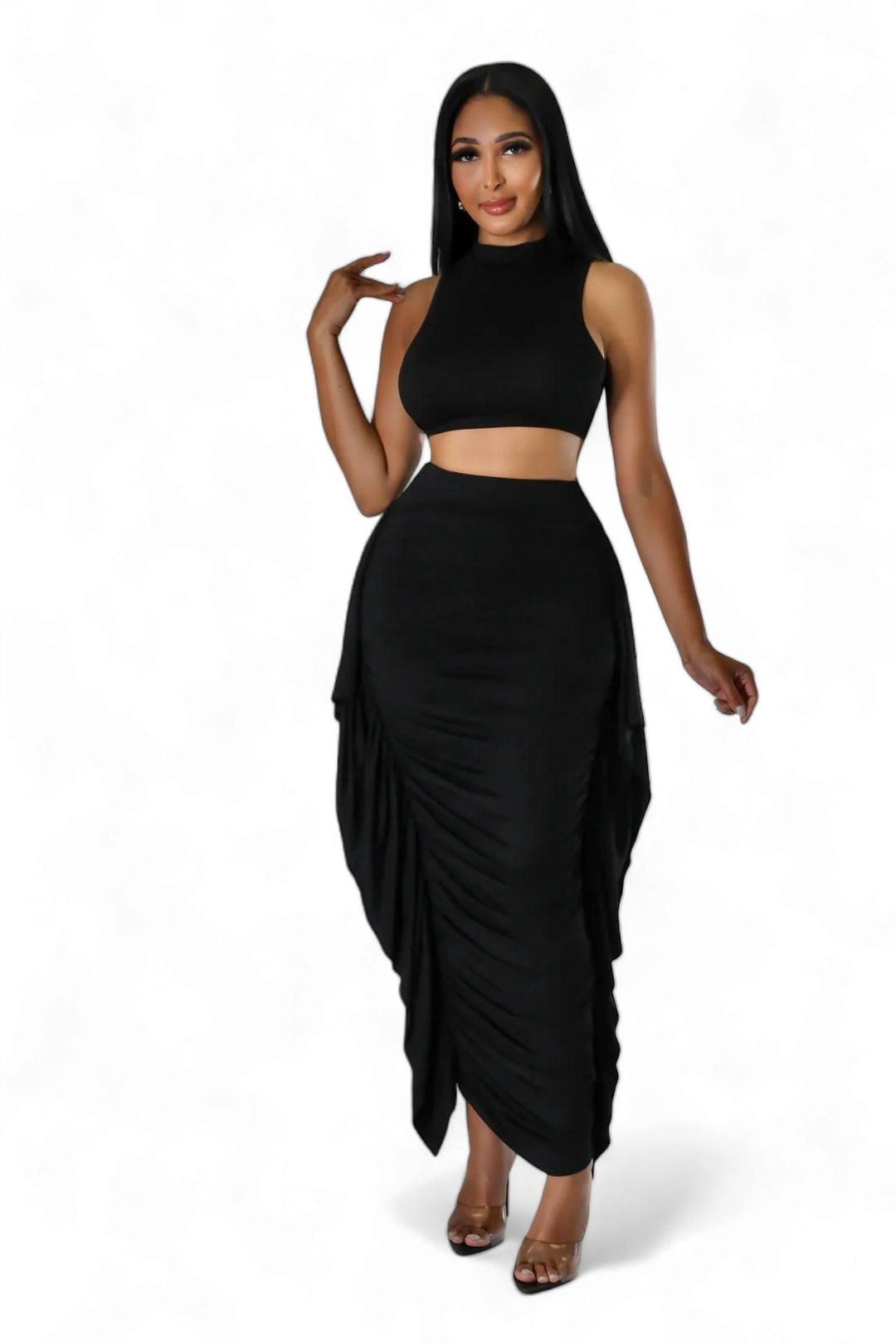 a woman wearing a black skirt and crop top