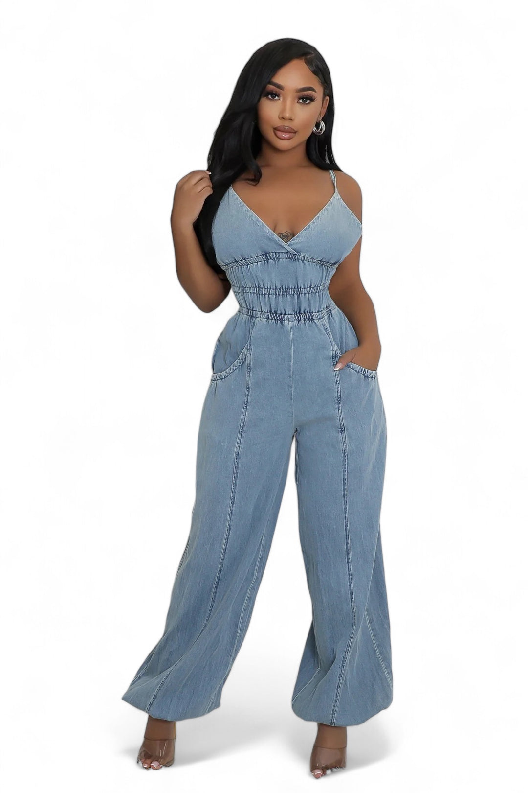 a woman in a denim jumpsuit posing for a picture