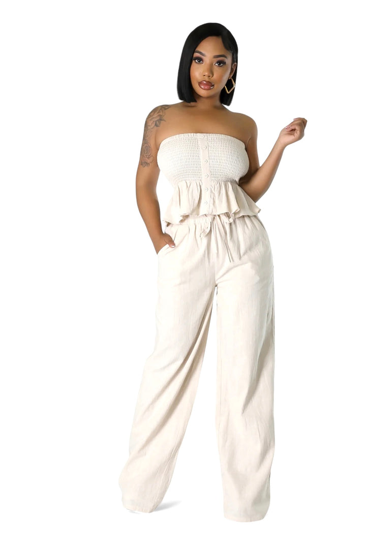 a woman in a strapless top and wide legged pants