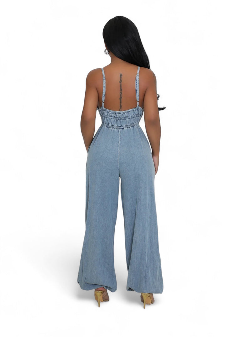 the back of a woman wearing a denim jumpsuit