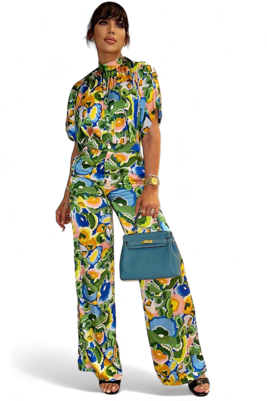 a woman in a colorful outfit holding a blue purse