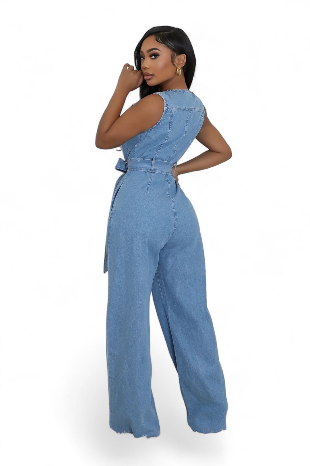 a woman wearing a denim jumpsuit and heels