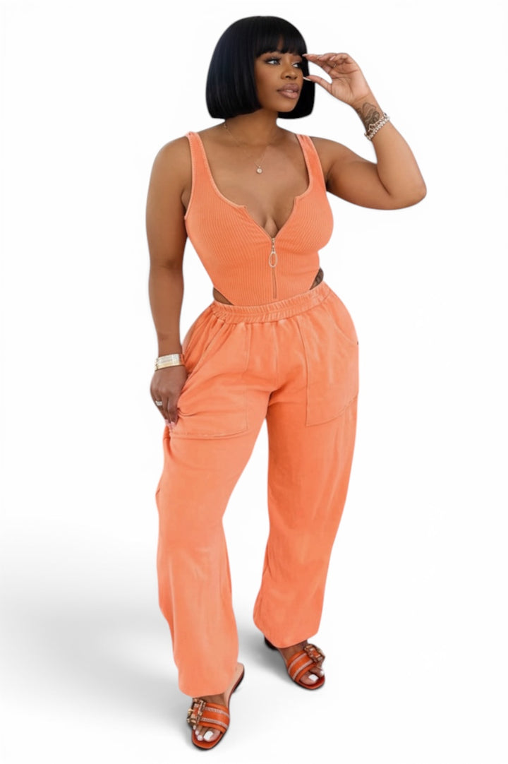 ORANGE ribbed zip-front bodysuit with side cutouts paired with matching JOGGING PANTS 
