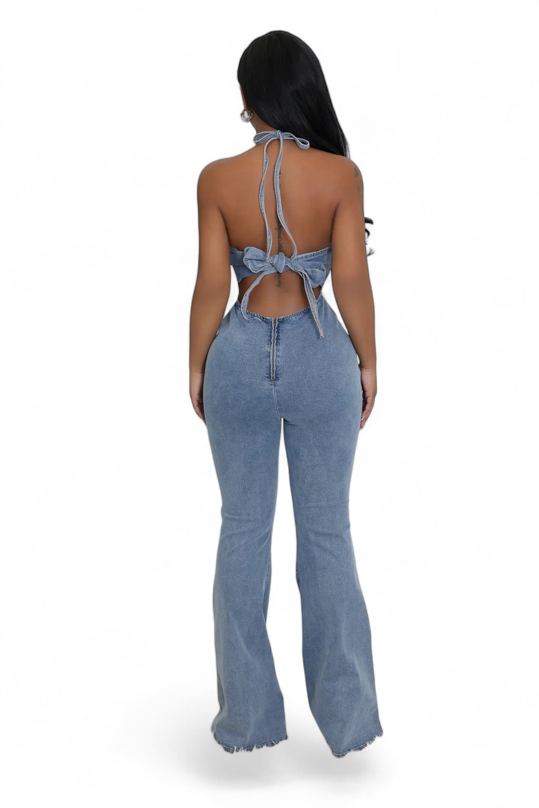 the back of a woman wearing a denim jumpsuit