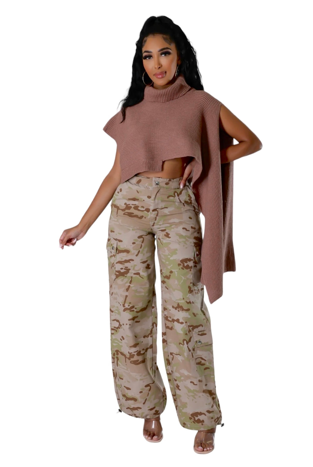 a woman in a pink sweater and camo pants