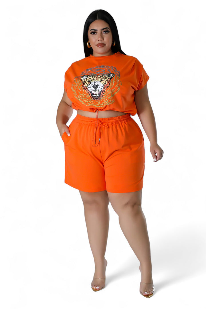 a woman in an orange top and shorts