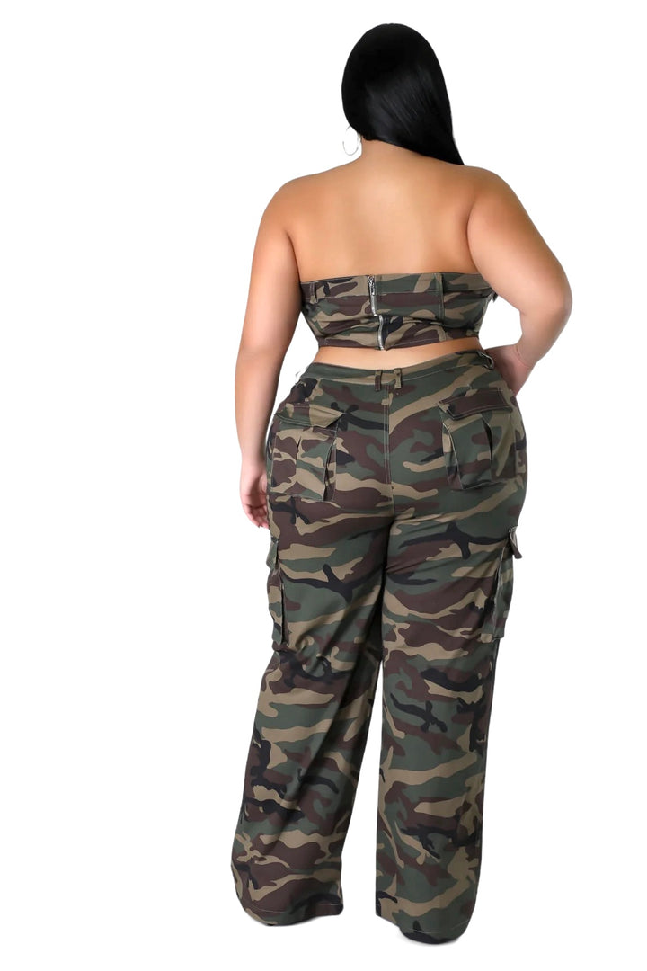 a woman in camouflage print pants and a strapless top