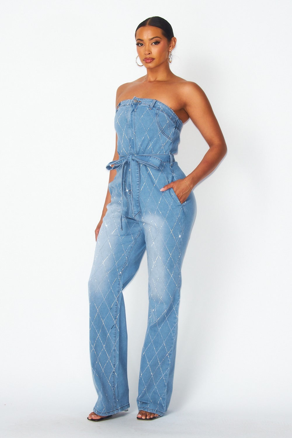 a woman wearing a denim jumpsuit with a strap