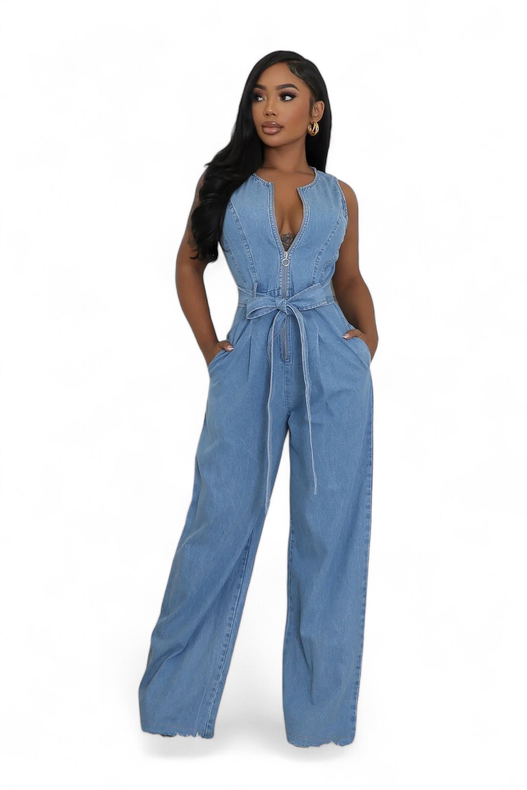 a woman wearing a denim jumpsuit and heels