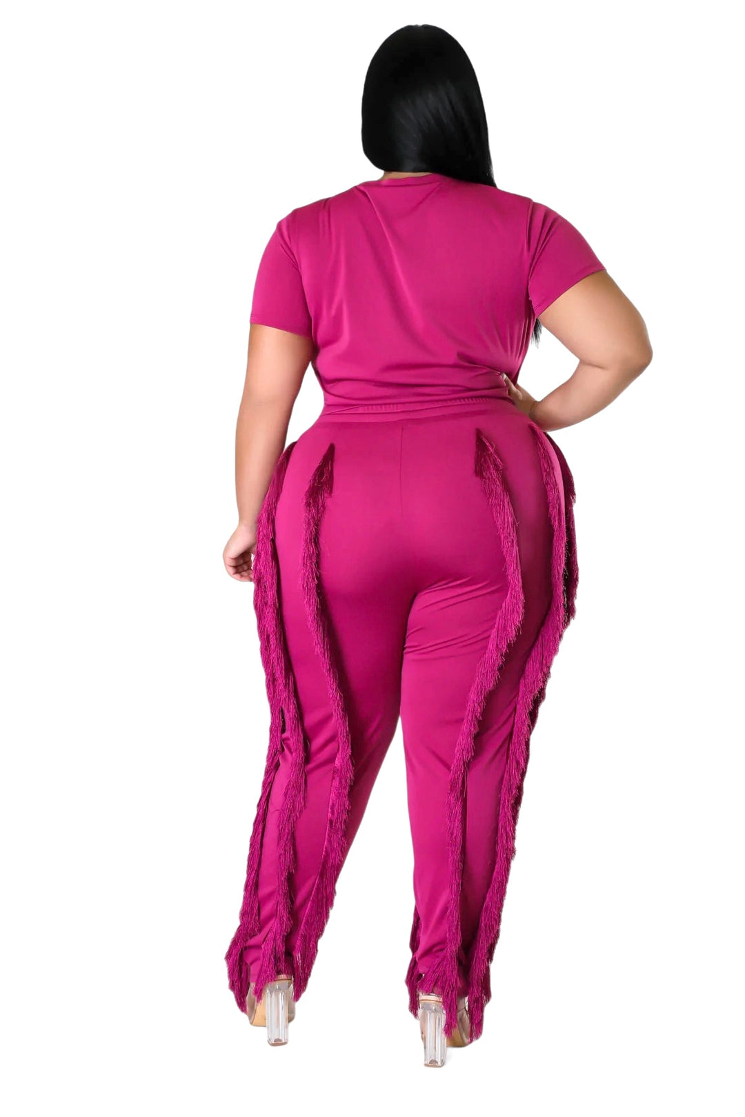 a woman wearing a pink jumpsuit with ruffles