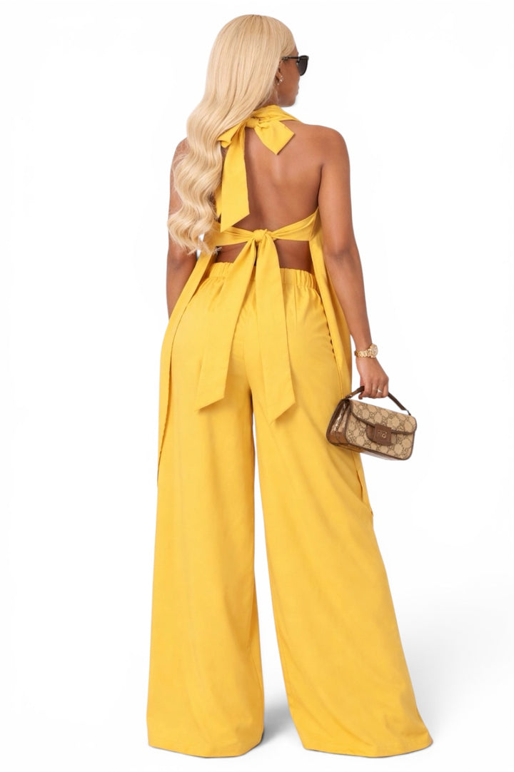 Woman wearing a yellow two piece set showing back of set 