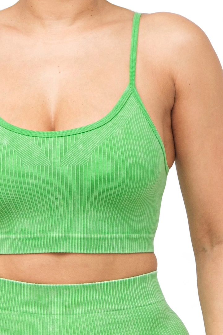 a close up of a woman wearing a green top