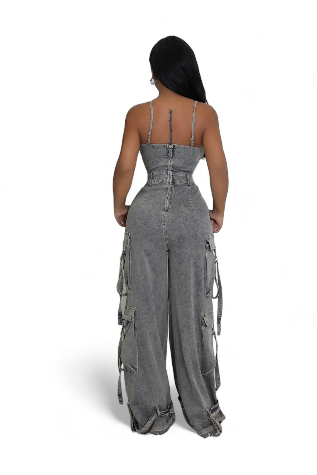 a woman in grey jumpsuits with straps