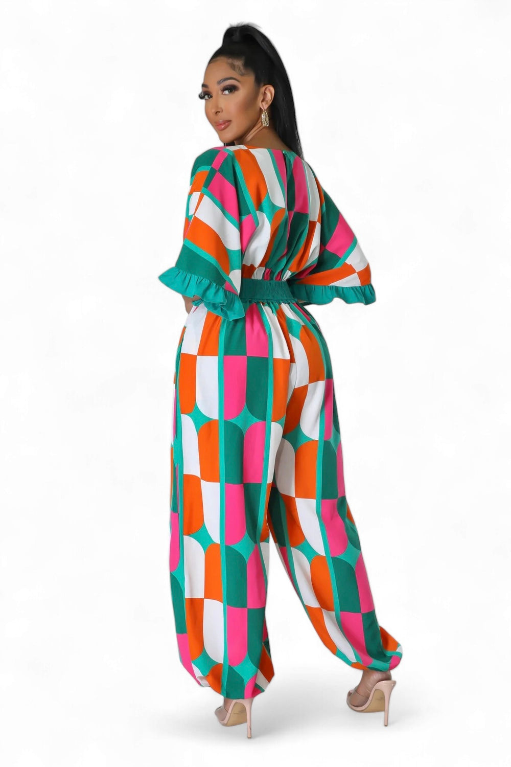 a woman in a colorful checkered jumpsuit