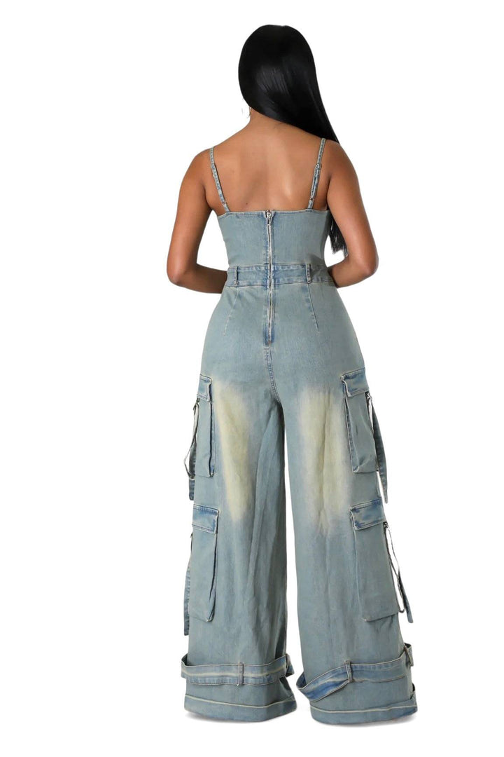 a woman wearing a denim jumpsuit with straps