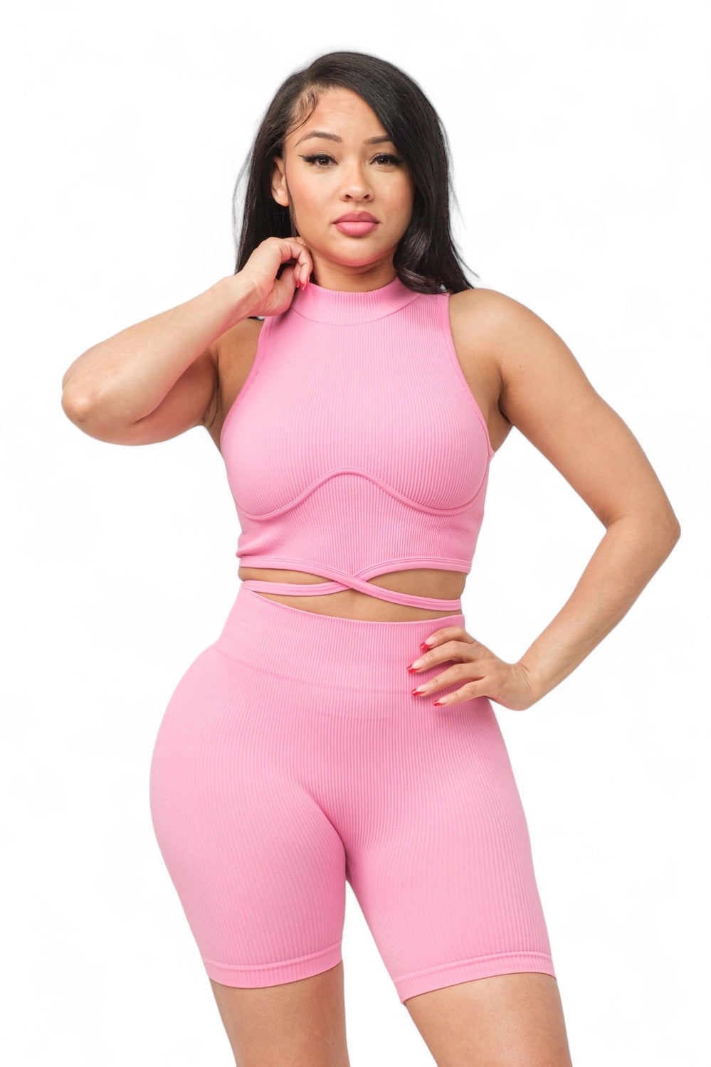 a woman in a pink outfit posing for the camera