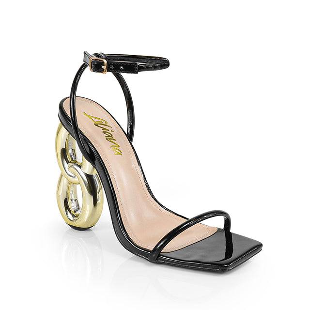 a black and gold high heeled sandal