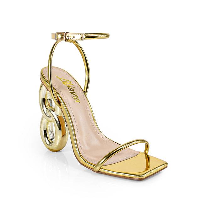 a pair of gold high heeled sandals