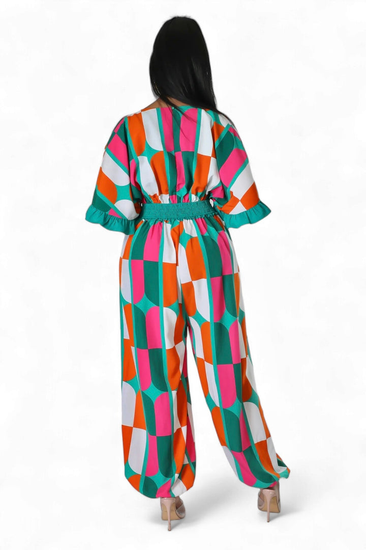 a woman is wearing a colorful jumpsuit