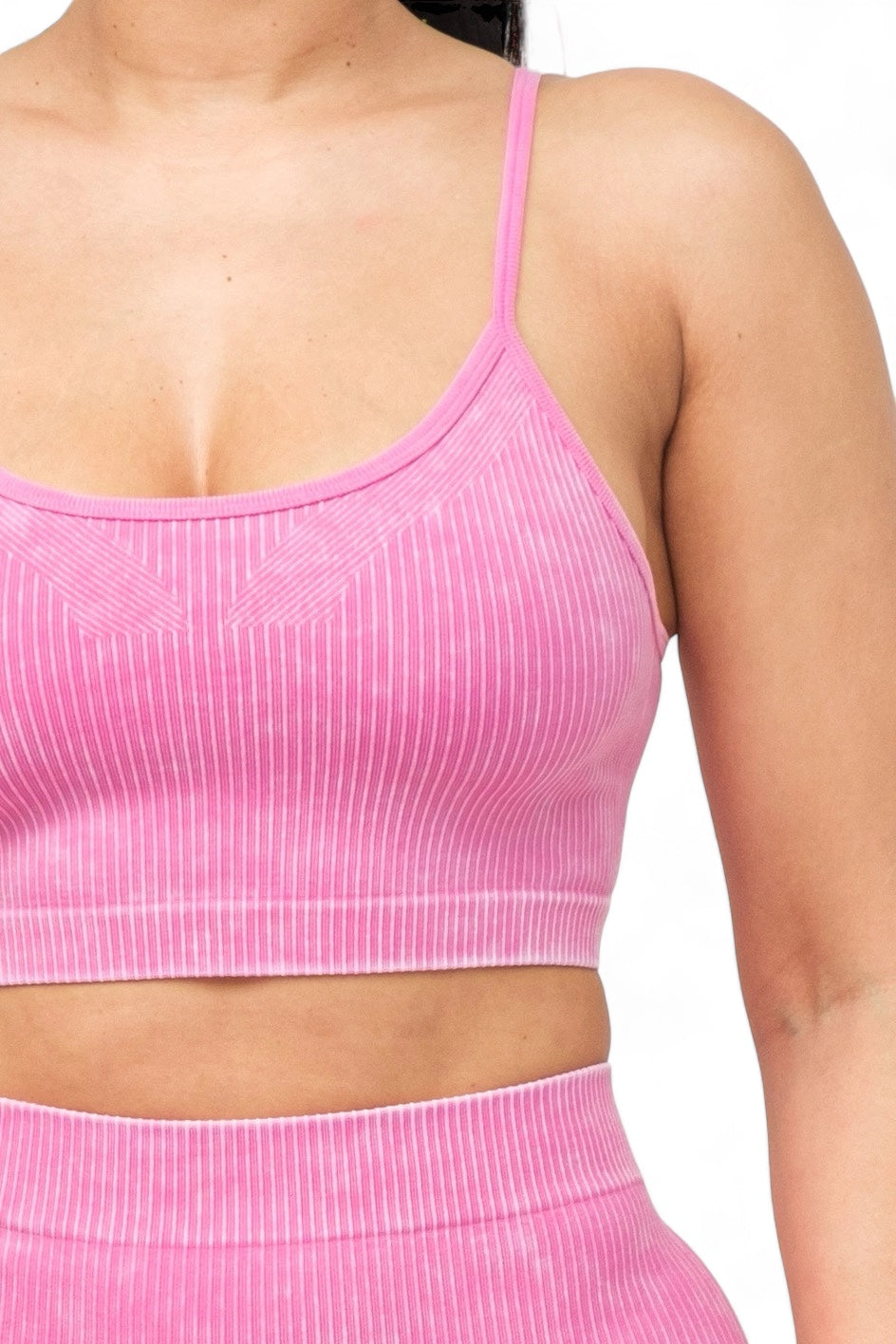 a close up of a woman wearing a pink top