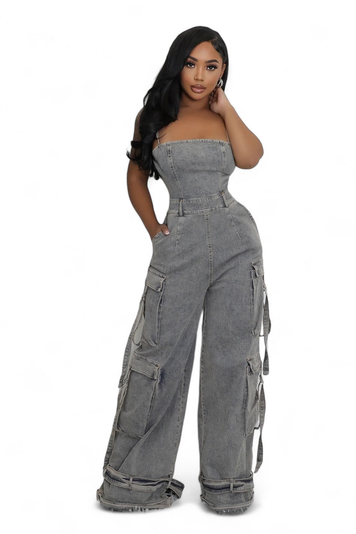 a woman in a denim jumpsuit posing for the camera