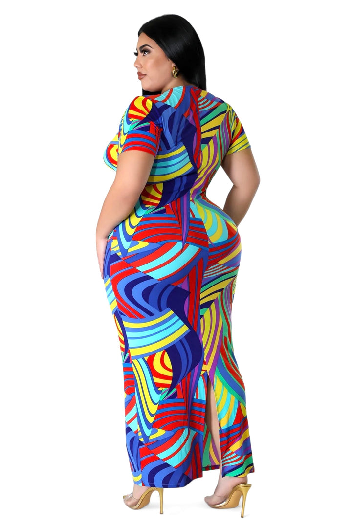 a woman in a colorful dress is posing for a picture