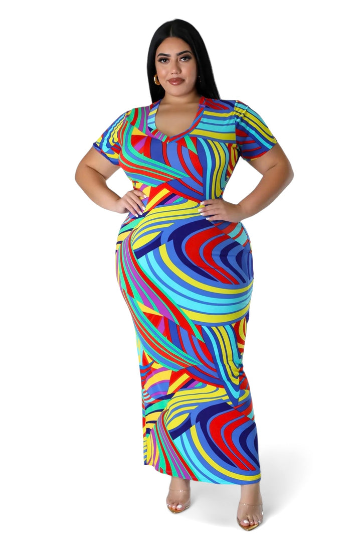 a woman in a colorful dress posing for a picture