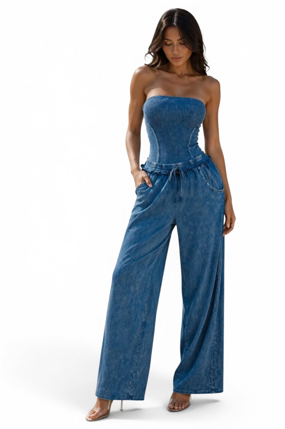 Women's strapless blue denim wide-leg jumpsuit with ribbed corset-style bodice, drawstring waist, pockets, and relaxed fit.