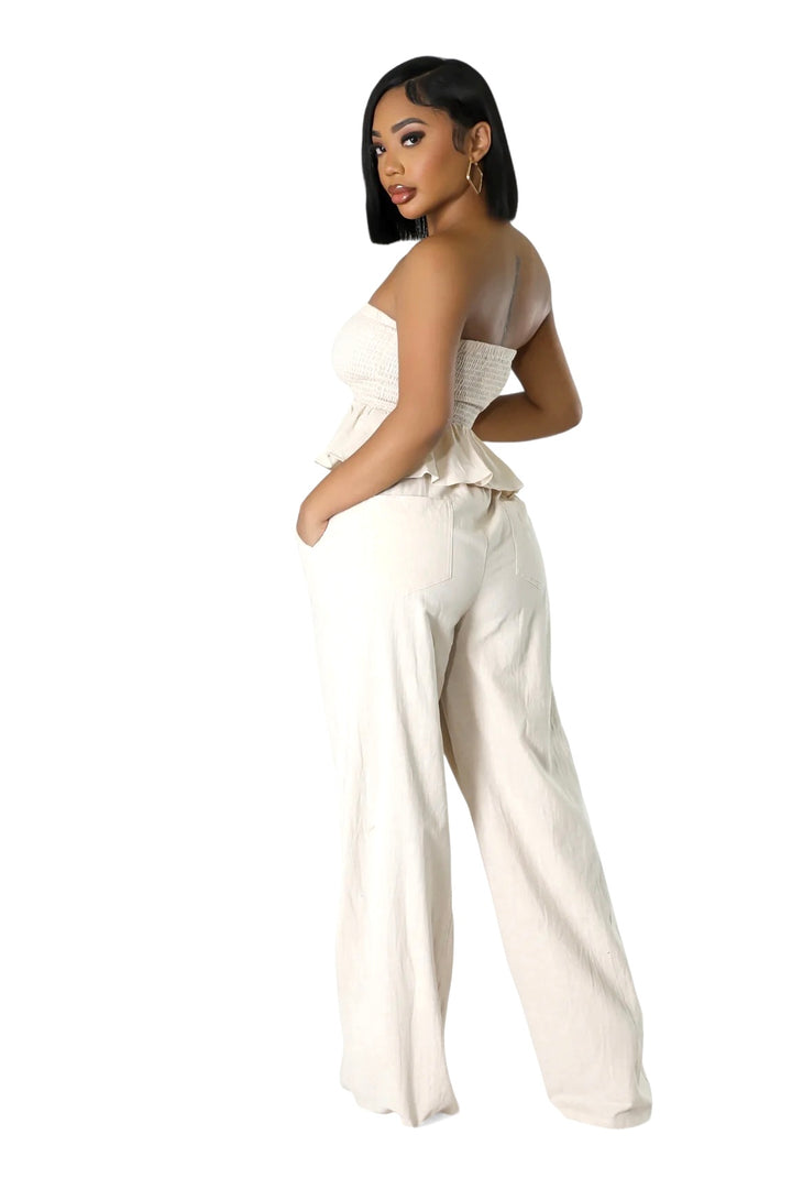 a woman in a white jumpsuit posing for a picture